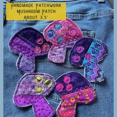 the back of a pair of jeans with handmade patchwork on them