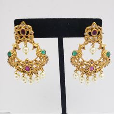 This beautiful earrings set has an excellent finish and gives out an exquisite sense of style. If you are looking for an amazing Fashion Jewelry set for special occasions such as Anniversary, Engagement, Party, Wedding, or for gifting, then your search ends here. Handmade Indian Temple Jewelry, best to wear it for traditional ceremonies or Indian wedding. This bridal jewelry has an ethnic finish. It has Cubic Zircon stones with semi-precious ruby and emeralds. It is a Bollywood style one gram je Elegant Jeweled Chandbalis For Diwali, Jeweled Pearl Earrings For Wedding And Festivals, Festive Jeweled Pearl Earrings For Wedding, Jeweled Pearl Earrings For Wedding, Kundan Bridal Earrings In Temple Jewelry Style, Kundan Temple Jewelry Bridal Earrings, Kundan Bridal Earrings With Elegant Temple Design, Diwali Temple Jewelry Style Bridal Earrings, Diwali Temple Jewelry Bridal Earrings With Jewels