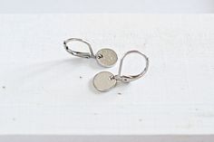 Minimalist, Hammered Circle Earrings, Dainty Round Drop, Lever Back, Silver Earring. These earrings are great for anyone who likes delicate, light weight jewelry.  - Material: Alloy, silver finish, light hammered tiny charm. Stainless steel lever back earrings.  - Size: The approximately length is 3/4 of an inch (20mm). The charm size is 5/16 (8mm) in diameter.  - Quantity: One (1) pair. - Jewelry is shipped in packaging ready for gift giving. Thanks for visiting... Nickel-free Round Minimalist Earrings, Minimalist Round Disc Earrings With Ear Wire, Minimalist Silver Round Pendant Earrings, Minimalist Hypoallergenic Round Disc Earrings, Nickel Free Minimalist Circle Earrings, Nickel-free Minimalist Circle Earrings, Minimalist Nickel-free Circle Earrings, Minimalist Nickel-free Circular Earrings, Simple Circle Nickel-free Earrings