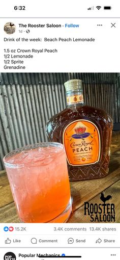 a bottle of booze sitting next to a glass filled with liquid on top of a wooden table