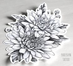 a black and white photo of flowers on a table with the words pawskin tattoo