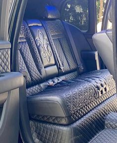 the interior of a vehicle with black leather and silver stitching on the front seats