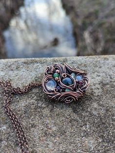 "This is one of my heaviest necklaces to date. It is made of mainly 20 gauge round copper wire and is a very solid piece. I started this piece with a labradorite as the center stone and used moonstone, opal, and goldstone cabochons around it. Then I added in amethyst, fluorite, aventurine, and garnet beads. I really tried to make this piece look more organic and flowing. The wire wraps in such a way that it looks like the stones are growing out of the wire.  This pendant comes on an 18\" copper Wire Wrap Necklace, Fluorite Necklace, Wire Wrap Jewelry Designs, Wire Pendants, Wrap Necklace, Sterling Silver Wire Wrap, Wire Wrap Jewelry, Handmade Wire Wrapped, Wrap Jewelry