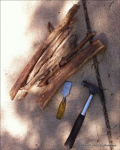 tools are laying on the ground next to some wood planks and nails, including a hammer