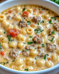 a white bowl filled with pasta and meatballs