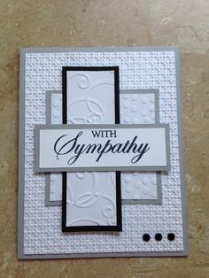 a card with the words sympathy written in black and white on it, sitting on a table