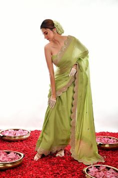 This elegant saree features a light green satin fabric and a stunningly hand-embroidered scalloped border. The gota patti design provides texture and dimension, making this saree a perfect choice for special occasions. Green Art Silk Pre-draped Saree With Embroidered Border, Designer Green Pre-draped Saree With Embroidered Border, Elegant Pista Green Dola Silk Pre-draped Saree, Elegant Green Lehenga With Embroidered Border, Green Dola Silk Pre-draped Saree For Reception, Green Resham Embroidered Dola Silk Pre-draped Saree, Pista Green Pre-draped Saree With Gota Work, Festive Green Pre-draped Saree With Embroidered Border, Designer Wear Green Sharara With Embroidered Border