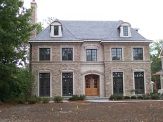 a large brick house with two story windows