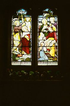 two stained glass windows in the dark with people standing next to each other and praying