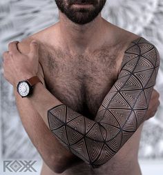 a man with a tattoo on his arm and wrist is looking at the camera while wearing a watch