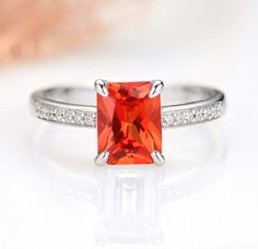 Gorgeous Vintage Inspired Orange Sapphire Ring ►Made of solid 925 sterling silver with the rhodium finish. ►Average band width: 1.6 mm ►Wedding band is sold separately. Center Stone: Sapphire Color: Orange Shape: Emerald Measurements: 6.0 x 8.0 mm Carat Weight: 1.7 ct. (approx.) Gemstone creation: Genuine Lab-Grown Sapphire Hardness: 9 (Mohs scale) Accent stones: Simulated Diamonds (CZ) ✓ 100% Nickel-Free ✓ Hypoallergenic ✓ Comfort Fit ✓ Free Ring Box ✓ Free USA Shipping Classic Orange Ring With Accent Stones, Classic Orange Rings For Anniversary, Orange Ring With Center Stone For Anniversary, Anniversary Orange Ring With Center Stone, Classic Radiant Cut Ruby Ring For Anniversary, Orange Ruby Ring For Anniversary, Anniversary Orange Ruby Ring, Classic Wedding Ruby Ring With Radiant Cut, Orange Emerald Cut Jewelry For Anniversary