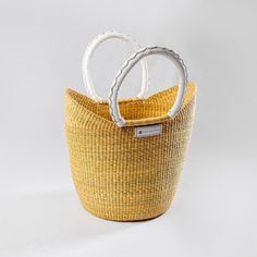 two white handles in a yellow basket on a white background with space for your text