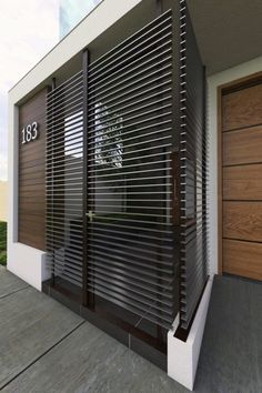 a modern house with wooden garage doors and windows