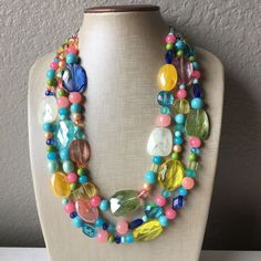 "Simply Gorgeous!! Pair this with almost any solid color top - white, blue, yellow, pink - all are equally gorgeous! Also looks perfect with a scoop neck dress. 3 strand necklace with an elegant mix of acrylic and glass beads in spring colors. 17\" Necklace with a 4\" extender chain. Silver finishing. Thank you for supporting American small and handmade business! Check out our other items: Www.PolkaDotDrawer.Etsy.com" Cheap Colorful Beaded Necklace With Large Beads, Cheap Colorful Beaded Statement Necklaces, Affordable Colorful Beaded Statement Necklaces, Luxury Statement Beaded Necklaces With Colorful Beads, Cheap Multicolor Long Necklace With Large Beads, Cheap Multicolor Beaded Necklace Statement Piece, Colorful Large Beaded Necklaces, Cheap Statement Jewelry With Colorful Beads, Luxury Statement Beaded Necklace With Colorful Beads