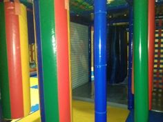 an indoor play area with colorful plastic pipes