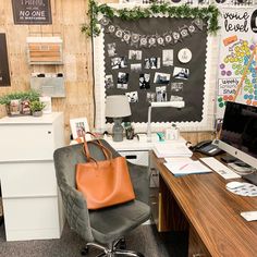 an office with a desk, chair and computer on it in front of a chalkboard