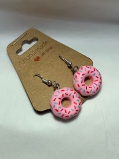 Cute pink donut dangle earrings. Great for everyday wear or to special gatherings. Made with resin and stainless steel. Nickel-free Pink Earrings For Everyday, Cute Pink Hoop Earrings For Everyday, Cute Pink Hoop Earrings For Everyday Wear, Everyday Pink Hypoallergenic Earrings, Pink Everyday Jewelry With Ear Wire, Nickel-free Pink Polymer Clay Jewelry, Pink Polymer Clay Jewelry With Ear Wire, Pink Doughnut, Donut With Sprinkles