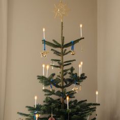 a small christmas tree decorated with blue and gold ornaments