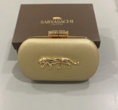 Sabyasachi inspired clutches available in different colors to enhance your attire! It is perfect for casual and party wear with a long metal chain. Every item is double checked for quality before being shipped out. Size: 7.5 L x 2 W x 4.5 H inches approx. Normal size phones easily fit into these clutches. We ship out within 2 -3 days of receiving the order. We will ship out within 24 hours upon request. If you have any questions, please do message us and we will respond back. Packaging: We offer Designer Silver Clutch As A Gift, Elegant Gold Clutch With Openable Feature, Gold Formal Clutch With Openable Detail, Elegant Gold Clutch With Opening Mechanism, Luxury Gold Clutch For Wedding Guest, Formal Gold Clutch, Luxury Openable Clutch For Gift, Luxury Openable Clutch As A Gift, Designer Gold Clutch For Formal Events