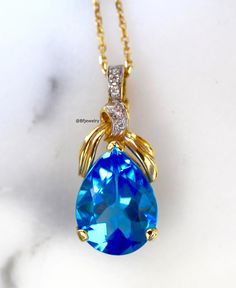 Metal: 14kt Yellow Gold Stone: Diamond And Swiss Blue Topaz Stone Shape: Round And Pear-Shape Swiss Blue Topaz Weight: 9.36 ctw Diamond Weight: .36 ctw Weight of entire piece with chain: 6.60 grams Type of Lock: Lobster Clasp Type of Bail: Enhancer (This is great for clipping the pendant onto wide chains. Length Of Pendant From Top To Bottom: 28 mm Type of chain: 14kt Yellow Gold 1.2mm Diamond Cut Role Chain Length of chain: 16 Inch Note: Other chains available, or you can purchase the pendant w Pear-shaped Blue Topaz Yellow Gold Jewelry, Blue Topaz Pear-shaped Jewelry, Luxury Blue Pear-shaped Necklace, Blue Pear-shaped Topaz Jewelry, Blue Topaz Necklace With Accent Stones, Blue Topaz Necklaces With Accent Stones, Blue Topaz Pear-shaped Necklace, Blue Pear-shaped Blue Topaz Necklace, Blue Topaz Necklaces With Diamond Accents