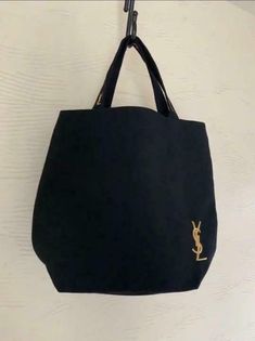 Yves Saint Laurent  Black Tote Bag Embroidered Gold Logo Zip Closure This item was a promotional gift from Yves Saint Laurent. ・YSL gold logo on the front and handles ・Zip closure ・Interior pocket ・Dimensions: (approx.) H 33 × W 38 × D 11 cm, Handle height 18.5 cm      CONDITION: New, 100% Authentic  PAYMENT: Only Paypal * Please note payment due with 3 days following the action SHIPPING: ship to Worldwide via registered mail * All orders will shipped out within 5 business day after receiving yo Designer Embroidered Bags For Daily Use, Designer Shoulder Bag With Embroidered Logo For Everyday, Chic Bags With Embroidered Logo For Daily Use, Designer Bags With Embroidered Logo For Everyday Use, Elegant Bags With Embroidered Logo For Everyday Use, Everyday Black Shoulder Bag With Embroidered Logo, Elegant Shopping Bag With Embroidered Logo, Elegant Shopping Bags With Embroidered Logo, Designer Canvas Shoulder Bag With Embroidered Logo