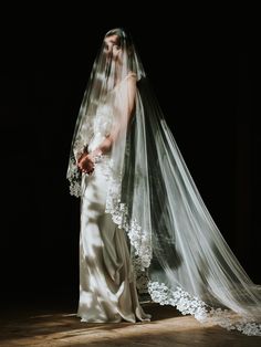 a woman in a wedding dress and veil