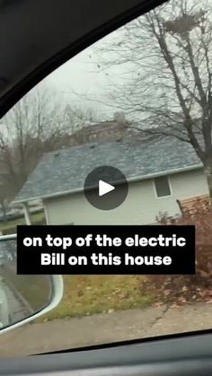 a car is parked in front of a house with the words on top of the electric bill on this house