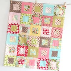 a patchwork quilt hanging on the wall