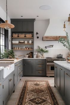 a kitchen with gray cabinets and an area rug