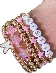 Gold Stretch Bracelet With Letter Beads, Dainty Beaded Name Bracelet With Round Beads, Dainty Name Bracelet With Round Letter Beads, Dainty Stretch Bracelet With Letter Beads, Pink Stackable Round Beads Name Bracelet, Custom Name Stretch Bracelet With Round Beads For Birthday, Pink Stackable Name Bracelet With Round Beads, Trendy Stackable Name Bracelet With Round Beads, Trendy Gold Beaded Bracelet For Birthday