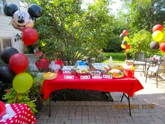 a mickey mouse themed birthday party with balloons