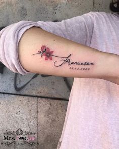 a woman with a tattoo on her arm that says, amanepa and flowers