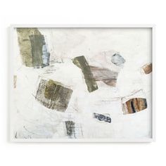 an abstract painting in white frame with brown and green paint on the wall behind it