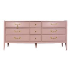 a pink dresser with gold handles and drawers on the bottom, against a white background