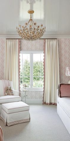 a bedroom with pink and white walls, chandelier, chair, bed and window