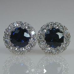 You will LOVE these little stud earrings.They are classic and chic. They are very petite style earring. The entire earring is 6.5mm wide in diameter. The blue sapphire color is beautiful and rich.The two center blue sapphire weight is .58 cts.The earrings are 6.5 mm wide.The diamonds are VS/G  Quality .18 cts total weight.The friction backs are 14k white gold.The TCW is .76 cts.The color combination of the bright white of the 18k white gold settings against the bright and intense color of the bl Platinum Hallmarked Anniversary Earrings, Platinum Hallmarked Earrings For Anniversary, Luxury White Gold Cluster Earrings For Formal Occasions, Formal Hallmarked Platinum Earrings, Classic Blue Platinum Earrings, Luxury Sapphire Diamond Earrings With Brilliant Cut, Formal White Gold Cluster Earrings Hallmarked, Formal Round Platinum Cluster Earrings, Luxury Sapphire Diamond Earrings For Anniversary