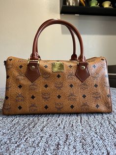 Authentic MCM women’s bag. See pics for overall condition. Designer Medium Bags For Daily Use, Formal Monogram Canvas Bag With Dust Bag, Formal Monogram Canvas Bag With Top Handle, Evening Monogram Canvas Tote Bag, Formal Monogram Canvas Tote Bag, Designer Satchel For Shopping, Designer Medium Bags For Everyday Use, Designer Medium Satchel For Shopping, Formal Monogram Canvas Satchel With Removable Pouch