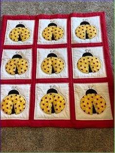 the ladybug quilt is made with red and white squares, which have yellow dots on them