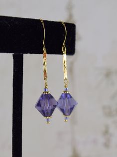 These beautiful crystal bicone in the lavender blue colour are dangling from Gold plated diamond-cut links and Gold plated hooks   They measure approximately 4.5cm from the tops of the hooks.  They are also available in silver plate, please make your choice from the list. Your earrings will be presented in a pretty gift bag.  The bag may vary from the picture...            Ces jolies cristaux bleu pervenche se balancent sur des crochets plaqués or et des liens biseautés.  La longueur de ces bouc Elegant Blue Faceted Crystal Earrings, Hypoallergenic Dangle Crystal Earrings For Formal Occasions, Faceted Crystal Dangle Earrings For Gift, Blue Faceted Long Drop Jewelry, Faceted Long Drop Earrings For Party, Elegant Blue Nickel-free Linear Earrings, Crystal Dangle Earrings With Ear Wire, Faceted Crystal Dangle Earrings, Faceted Dangle Earrings For Party