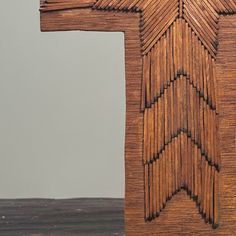 the cross is made out of wood and has an intricate design on it's side