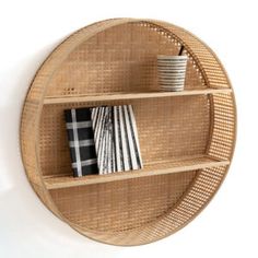 a wooden shelf with books and cups on it in the shape of a circular object