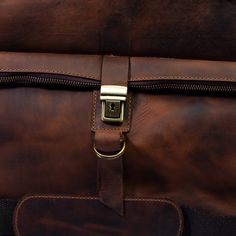 a brown leather briefcase with a gold buckle