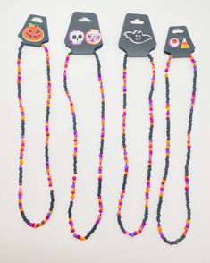 three halloween beaded necklaces are on display