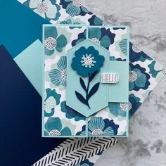 a blue and white card with flowers on it