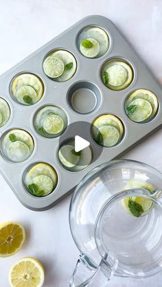 a muffin tin with lemons and mint in it next to a cupcake pan