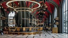 the interior of a restaurant with large chandeliers and tables in front of windows