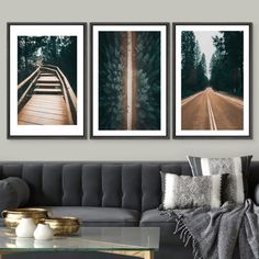 three framed photographs hang on the wall above a couch in a living room with a coffee table