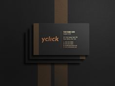 two black and brown business cards with the word yclck on them, sitting next to each other