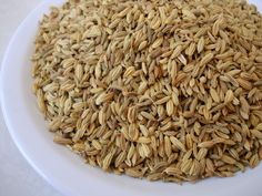 a pile of brown rice sitting on top of a white countertop next to a red frame