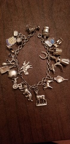 "Loaded Vintage 800 Silver European Charm Bracelet, Single Link Bracelet with 22 Charms, Some Charms are Quite Rare/Collectible This bracelet measures approximately 7 inches in length. It is a single link bracelet. It is marked \"800\" on a ring near the clasp. The bracelet has 22 charms. Most have their rings soldered on. All the charms are European. They may or may not be hallmarked. Most older European charms did not require a stamp or hallmark if they were below a certain weight. They are al Luxury Elegant Hallmarked Charm Bracelet, Luxury Traditional Jewelry With Vintage Charm, Luxury Metal Bracelet With Vintage Charm, Luxury Heirloom Bracelets With Vintage Charm, Luxury Elegant Bracelets With Vintage Charm, Moms Spaghetti, Army Dreamers, James Avery Charm Bracelet, Spanish Guitar